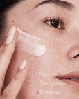 Woman applying a skincare product to her face with text indicating benefits.