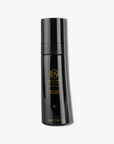 Black skincare bottle with gold text on a white background