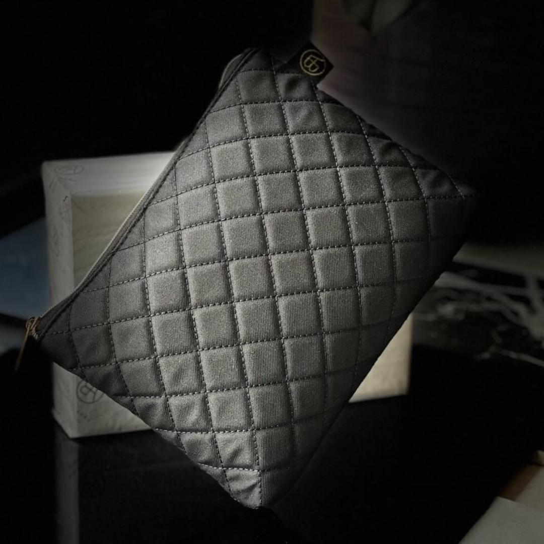 Close-up of a Bella Aura quilted pouch, showcasing its textured design, perfect for travel or luxury skincare storage.
