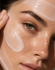 Close-up of a woman applying cream to her face