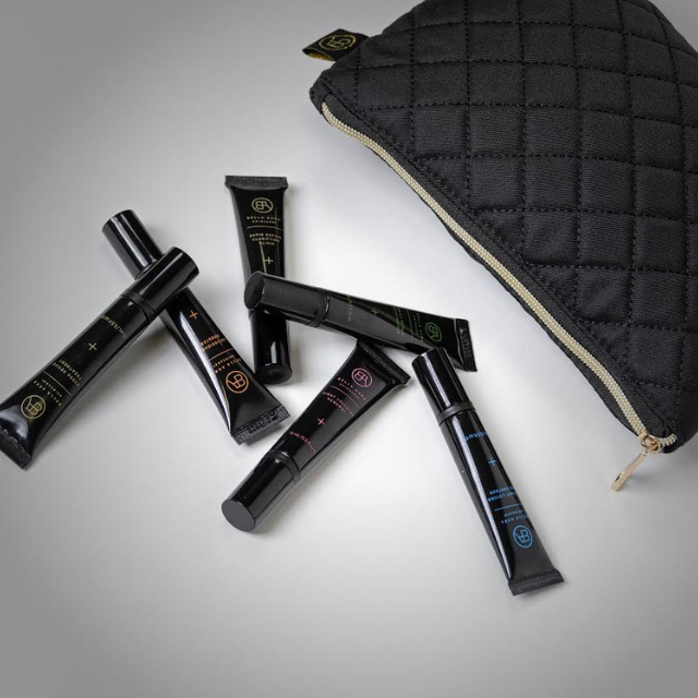 Bella Aura skincare tubes arranged next to a quilted black bag, showcasing the brand's commitment to sustainable packaging and eco-friendly skincare practices